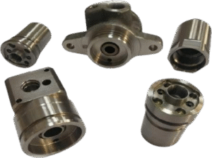 CNC Machining Group of CNC turned steel hydraulic valve pistons and aluminum manifolds for automotive transmissions.