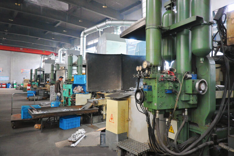 Modern die casting manufacturing workshop with automated machinery and clean production environment.